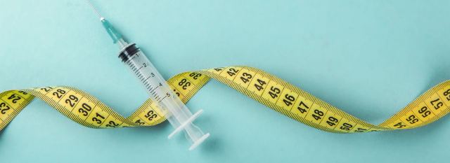 Syringe with measuring tape